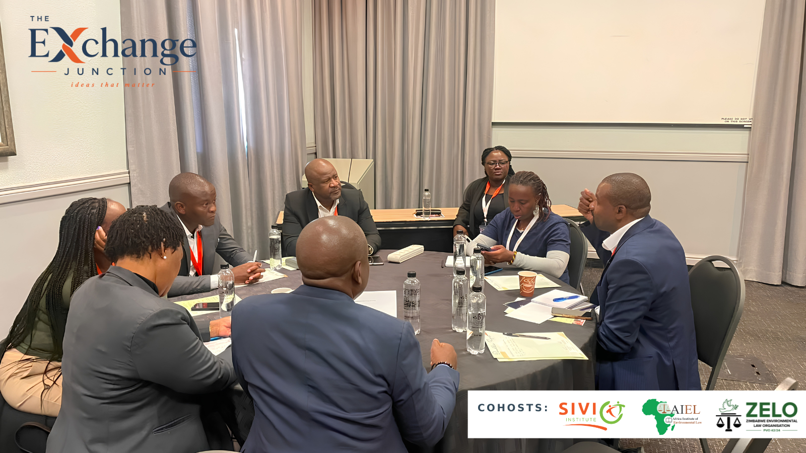Small group discussion around a table at the convening